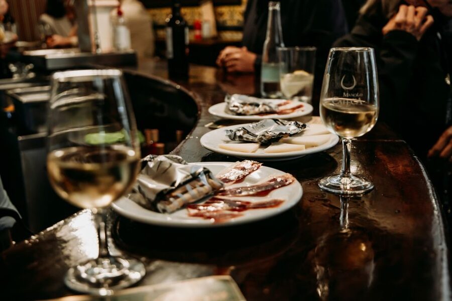 Triana: Authentic Flamenco & Tapas Tour - The abacería stop starts with wine and small bites